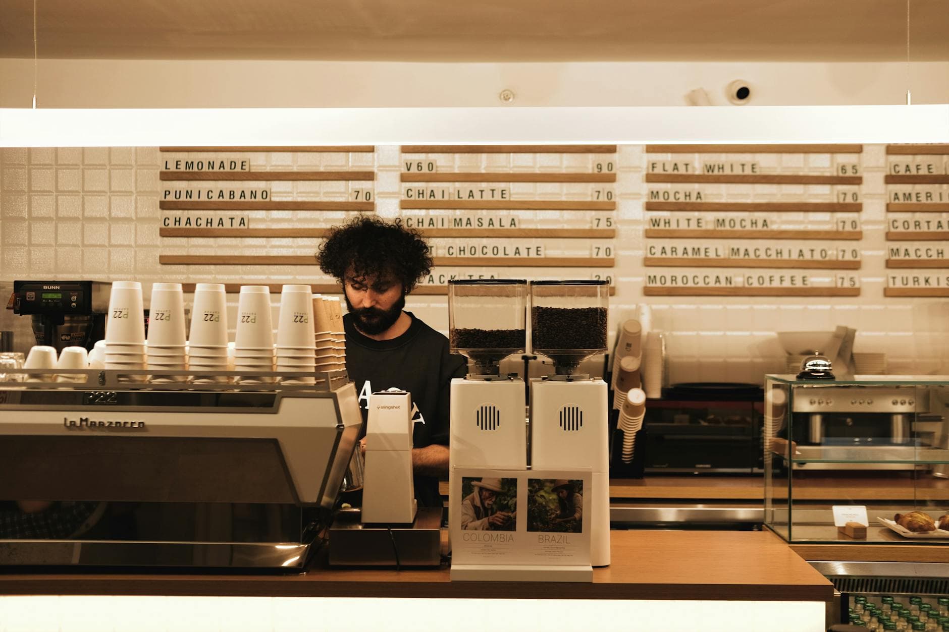 Barista making coffee at an espresso machine in a modern café