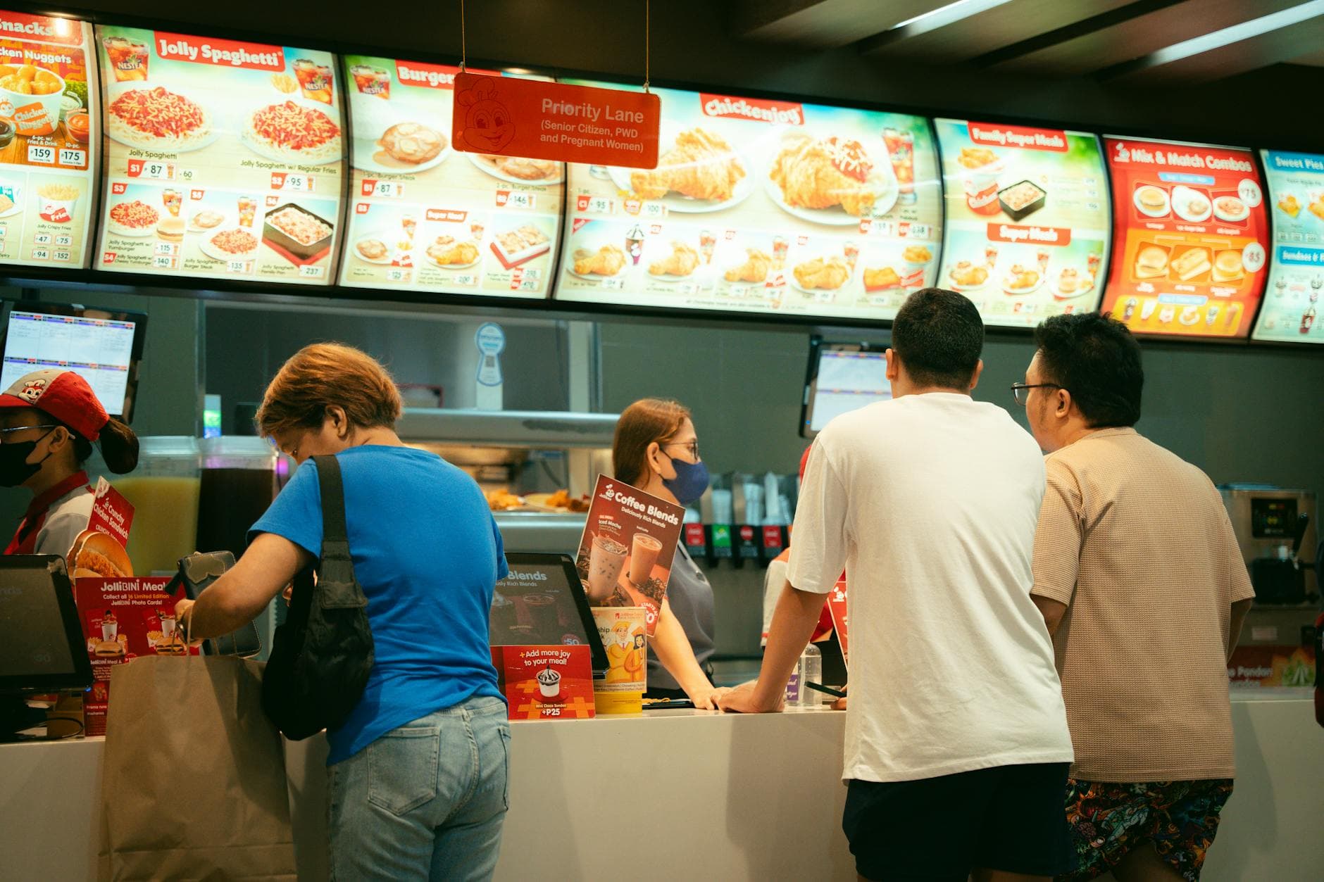 Customers ordering food at a fast food restaurant counter