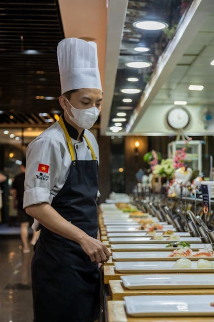 Chef preparing food in a busy restaurant kitchen